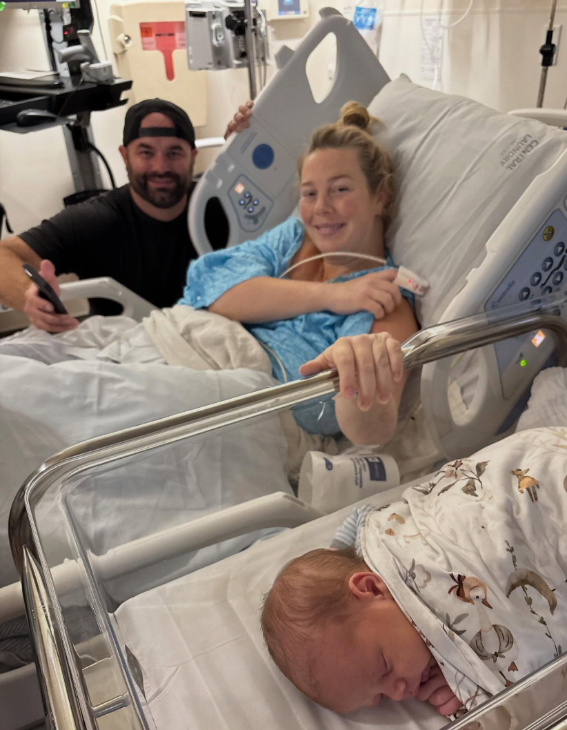 Brooke with Andrew and their newborn baby in the hospital